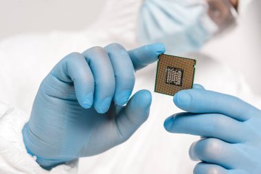 selective focus of microprocessor in hands of scientist