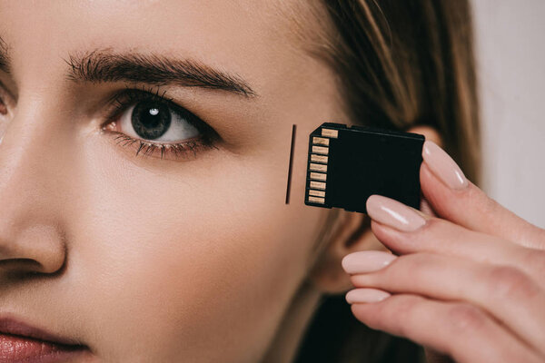 cropped view of woman implanting microchip in head