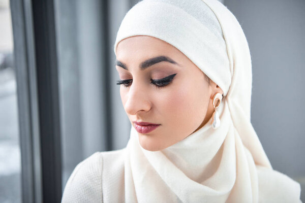 portrait of beautiful pensive young muslim woman looking down 