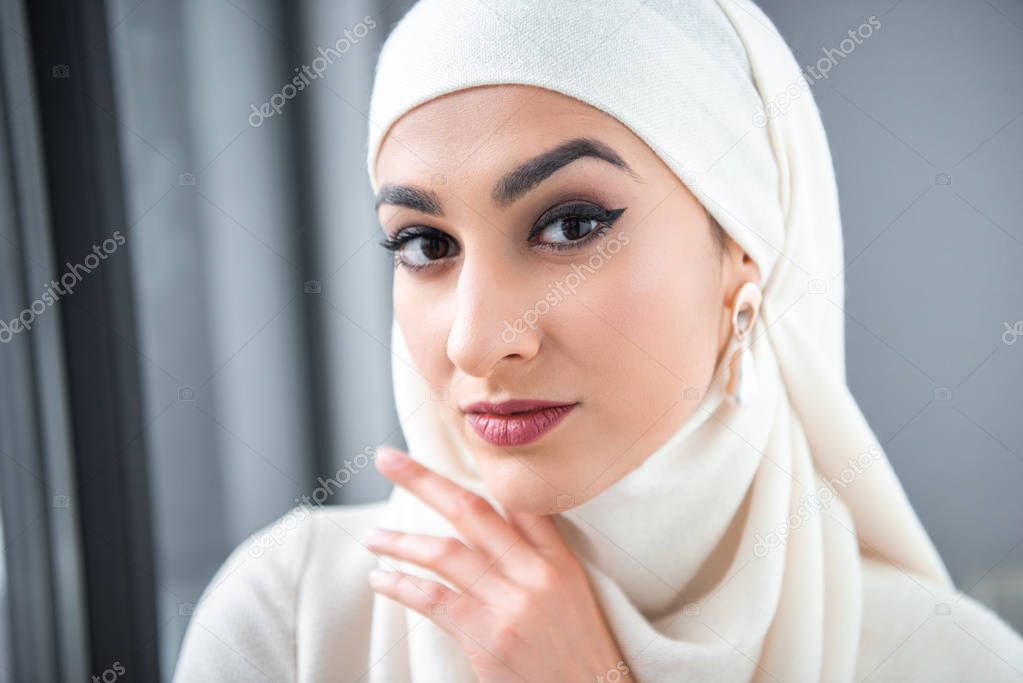 close-up portrait of beautiful young muslim woman looking at camera 