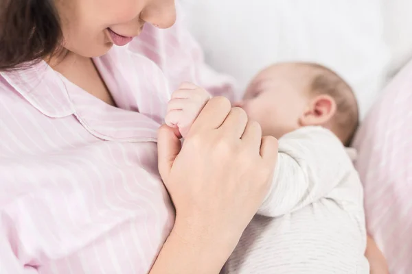 Partial View Cute Baby Sleeping Mothers Hands — Stock Photo, Image