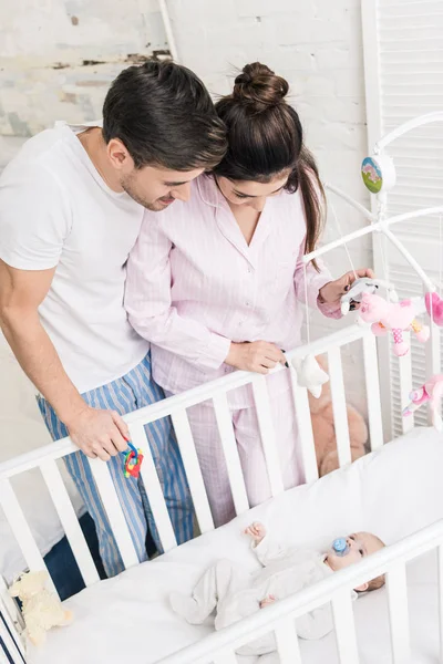 High Angle View Young Parents Looking Little Son Crib Home — Stock Photo, Image