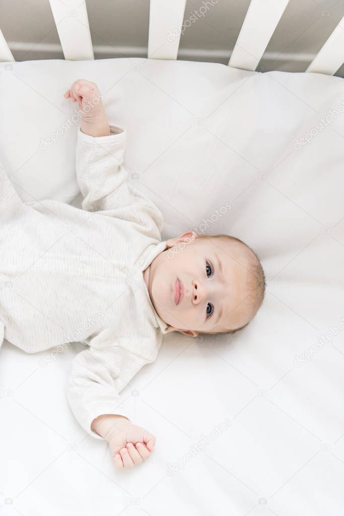 overhead view of adorable baby in crib