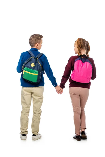 Achteraanzicht Van Kinderen Hand Hand Met Veelkleurige Rugzakken Geïsoleerd Wit — Stockfoto