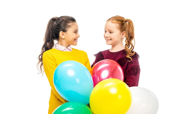 Smiling Schoolgirls Holding Colorful Balloons Looking Each Other Isolated White — Stock Photo, Image