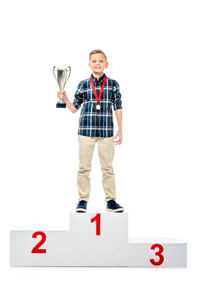 Smiling Boy Standing Winner Pedestal Holding Trophy Cup Looking Camera — Stock Photo, Image