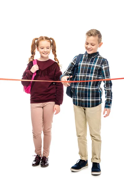 Smiling Schoolchildren Backpacks Cutting Red Ribbon Isolated White — Stock Photo, Image