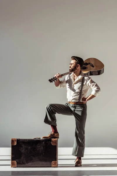 Бородатий Чоловік Шапочці Кладе Ногу Старовинну Валізу Тримає Акустичну Гітару — стокове фото