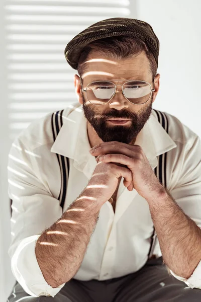 Bearded Man Glasses Cap Clenched Hands Chin Looking Camera White — Stock Photo, Image