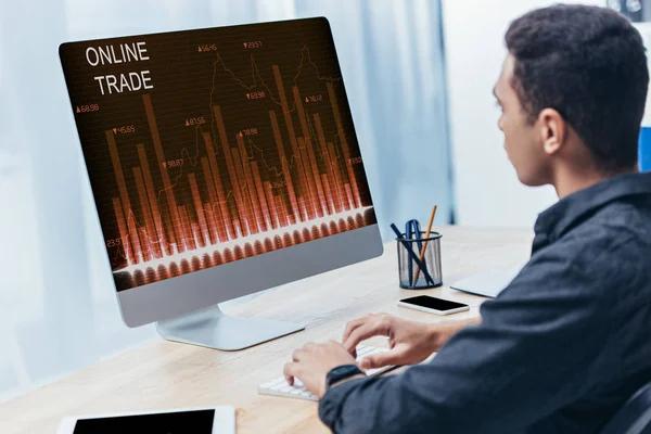 オフィスの画面でオンライン取引グラフでデスクトップ コンピューターを使用して青年実業家 — ストック写真