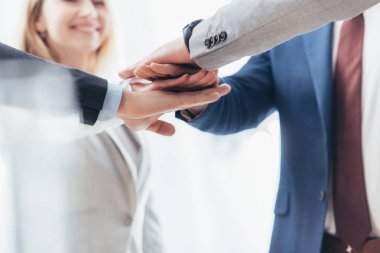 cropped shot of professional business people stacking hands together   clipart