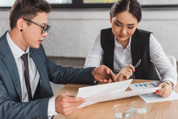 Professional Young Asian Business Colleagues Discussing Papers Workplace — Stock Photo, Image