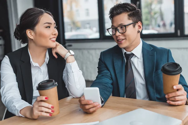 Unga Företagare Med Pappersmuggar Med Smartphone Och Leende Varandra Office — Stockfoto