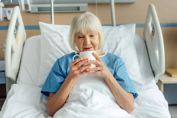 Senior Woman Lying Bed Drinking Tea Hospital — Stock Photo, Image