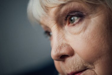close up of sad senior woman looking away clipart