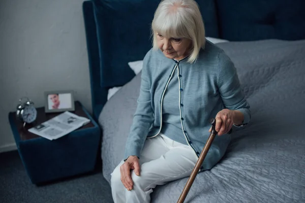 Selective Focus Upset Senior Woman Sitting Bed Walking Stick Home — Stock Photo, Image