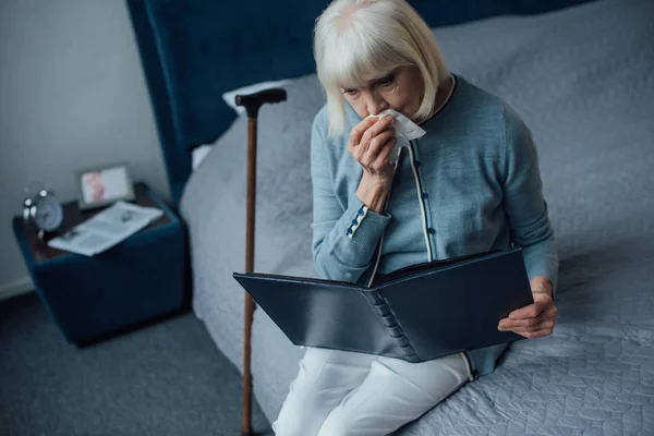 Sad Senior Woman Sitting Bed Looking Photo Album Wiping Tears — Stock Photo, Image