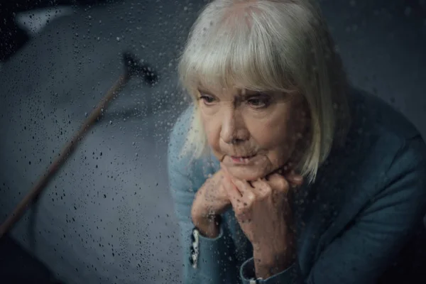 Depressed Senior Woman Sitting Propping Chin Hands Home Window Raindrops — Stock Photo, Image