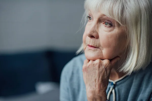 Portrait Thoughtful Senior Woman Propping Chin Hand Home — Stock Photo, Image