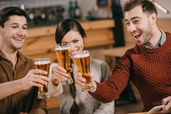 happy group of friends clinking with beer 