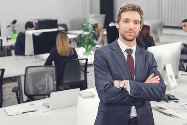 Confident Young Businessman Standing Crossed Arms Looking Camera Office — Stock Photo, Image