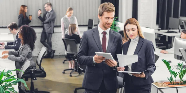 Professional Young Business Colleagues Discussing Papers While Standing Together Open — Stock Photo, Image