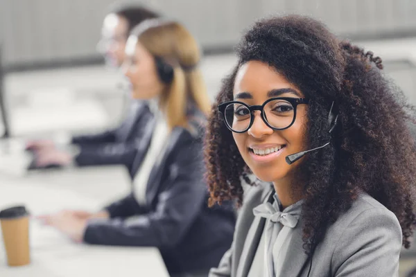 Hermosa Joven Afroamericana Mujer Auriculares Sonriendo Cámara Mientras Trabaja Con —  Fotos de Stock