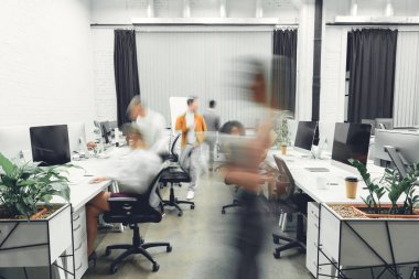 contemporary open space office interior with blurred coworkers in motion  clipart