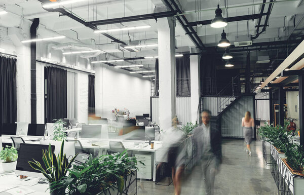 modern office interior with blurred businesspeople in motion 