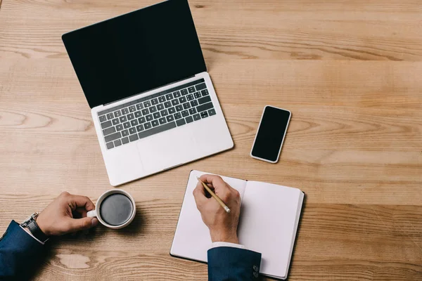 Partial View Businessman Writing Notebook Workplace Coffee Gadgets — Stock Photo, Image