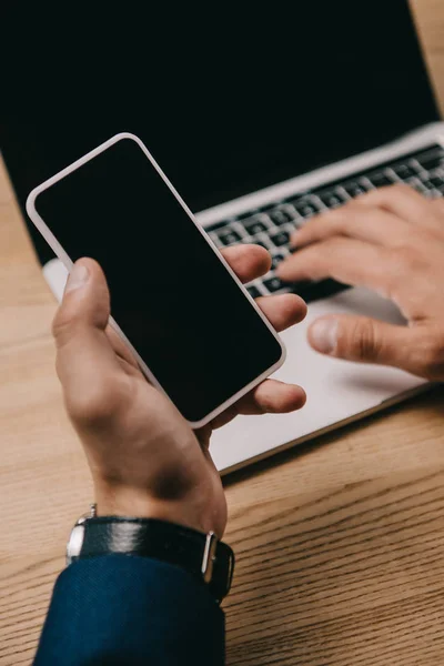 Vista Recortada Del Hombre Negocios Utilizando Teléfono Inteligente Mientras Escribe — Foto de Stock