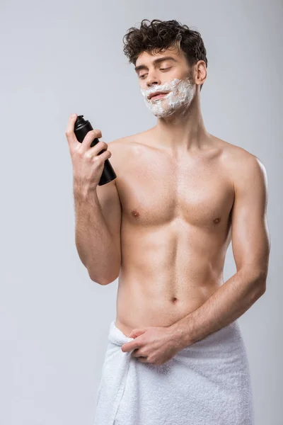 Handsome Young Man Towel Holding Bottle Shaving Foam Isolated Grey — 스톡 사진