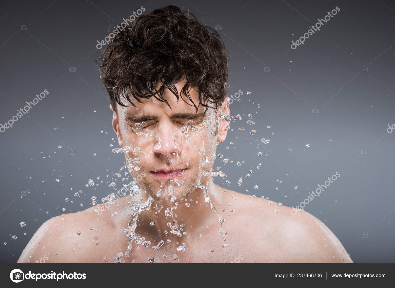 man washing face