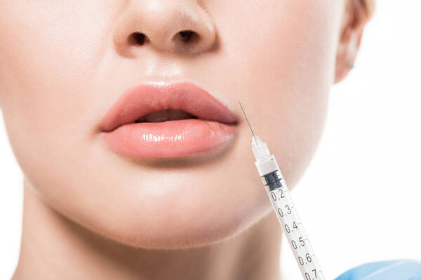 cropped shot of young woman receiving beauty injection in lips isolated on white 