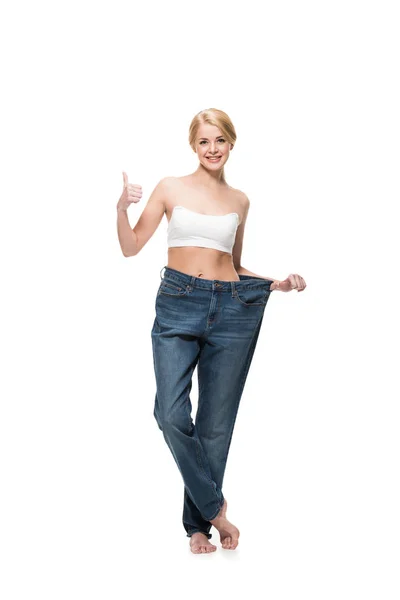 Happy Slim Woman Oversized Jeans Showing Thumb Smiling Camera Isolated — 스톡 사진