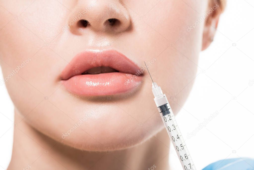 cropped shot of young woman receiving beauty injection in lips isolated on white 