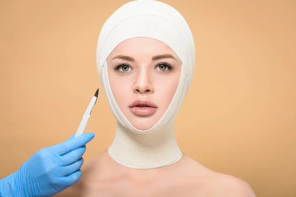 Cropped Shot Doctor Holding Scalpel Woman Bandages Head Isolated Beige — 图库照片