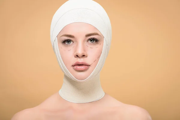 Young Woman Bandages Head Marks Face Looking Camera Isolated Beige — Stock Photo, Image