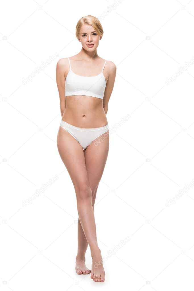 full length view of beautiful slim girl in underwear standing and looking at camera isolated on white 