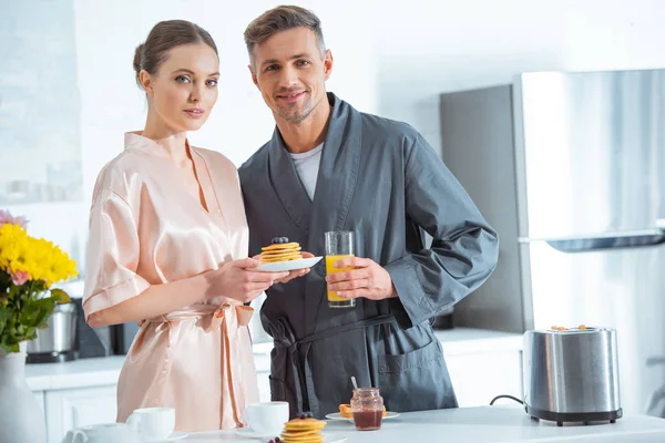 Selective Focus Beautiful Couple Robes Orange Juice Pancakes Breakfast Kitchen — Stock Photo, Image