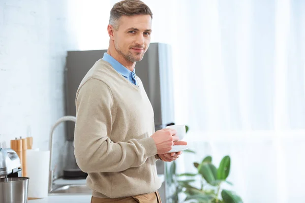 Handsome Man Casual Clothes Holding Coffee Cup Looking Camera Kitchen — Stockfoto