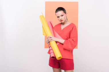 Kağıt tutan güzel moda kız kameraya bakıyor ve yaşam arka plan üzerinde mercan ile poz rulo