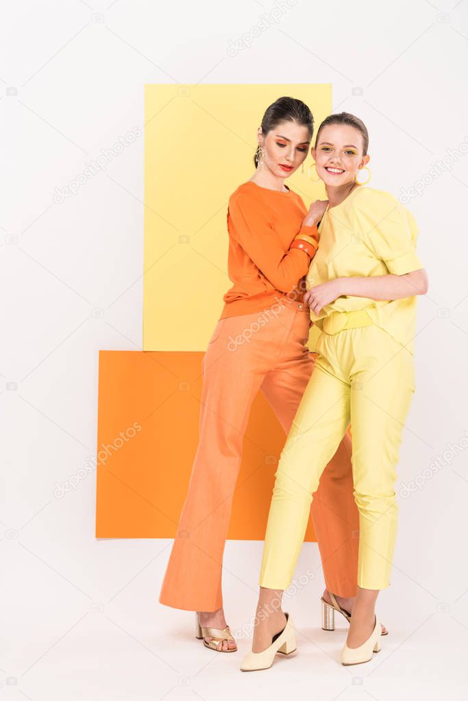 beautiful stylish girls posing with turmeric and limelight on background