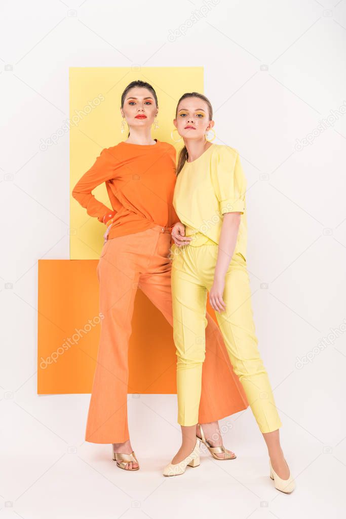 confident stylish girls posing with turmeric and limelight on background