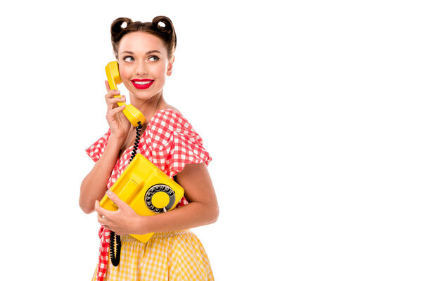 Attracive pin up girl talking on vintage yellow phone