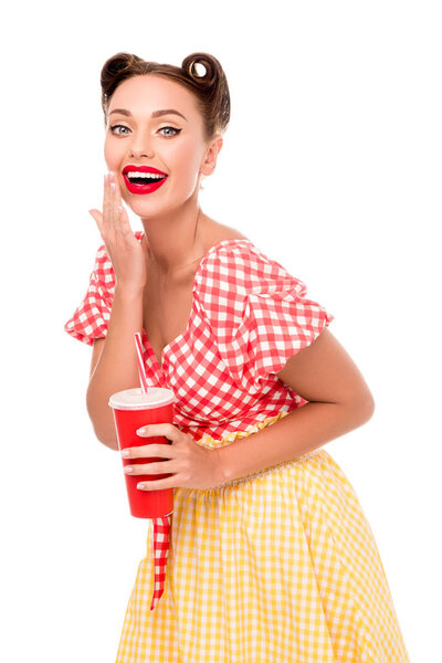 Smiling pretty pin up girl drinking from red paper cup with straw isolated on white