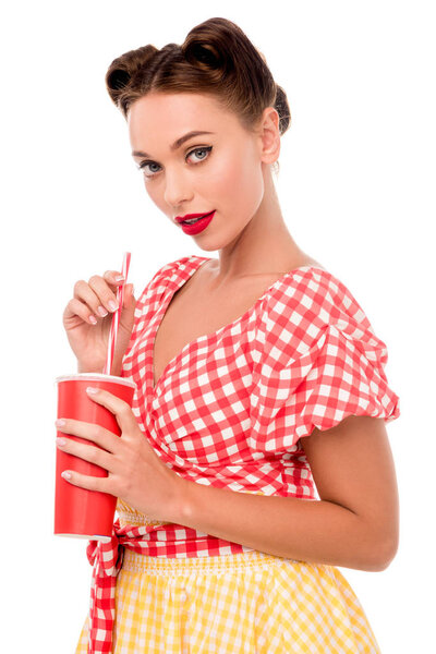 Pretty smiling pin up girl holding disposable cup and looking at camera isolated on white