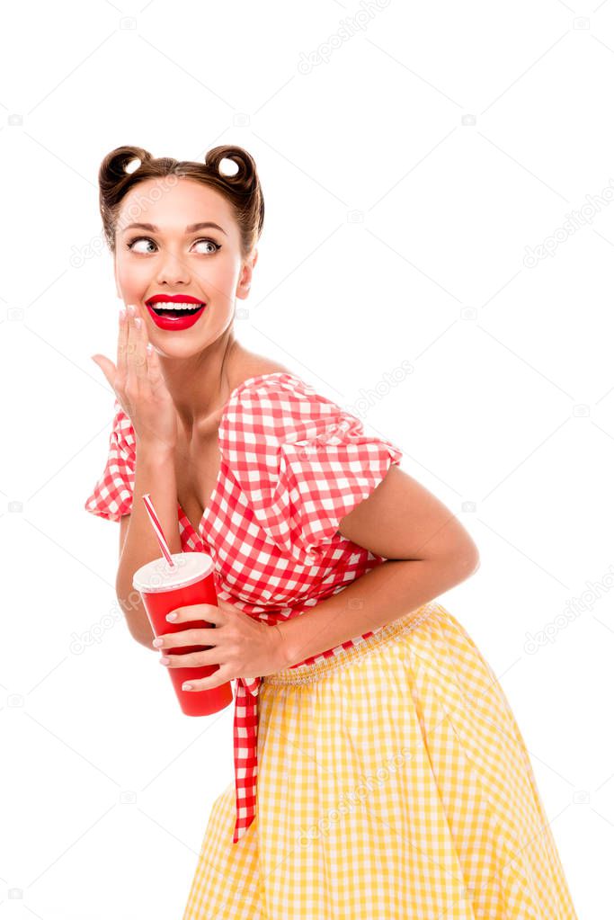 Young smiling pin up girl holding red paper cup with straw isolated on white
