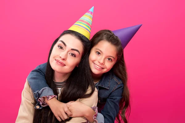 Happy Mother Daughter Party Hats Hugging Smiling Camera Isolated Pink — Stock Photo, Image