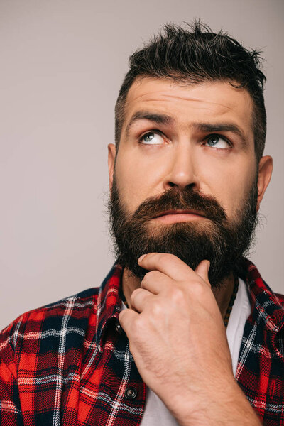 handsome thoughtful bearded man isolated on grey 